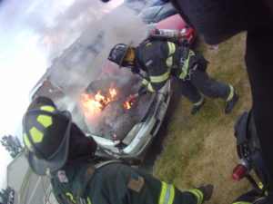 Firefighter Valentiner gaining access to the engine compartment. 